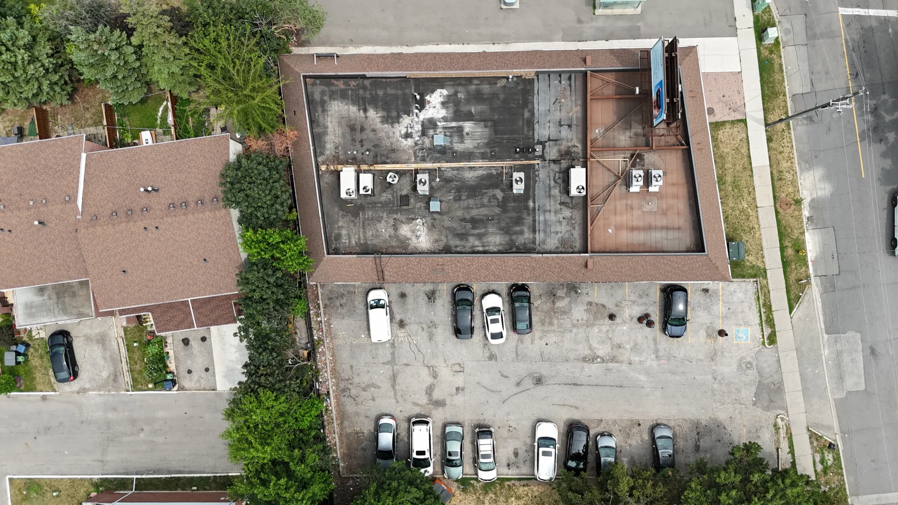 Aerial overview of a commercial building roof and its distributed mechanical equipment