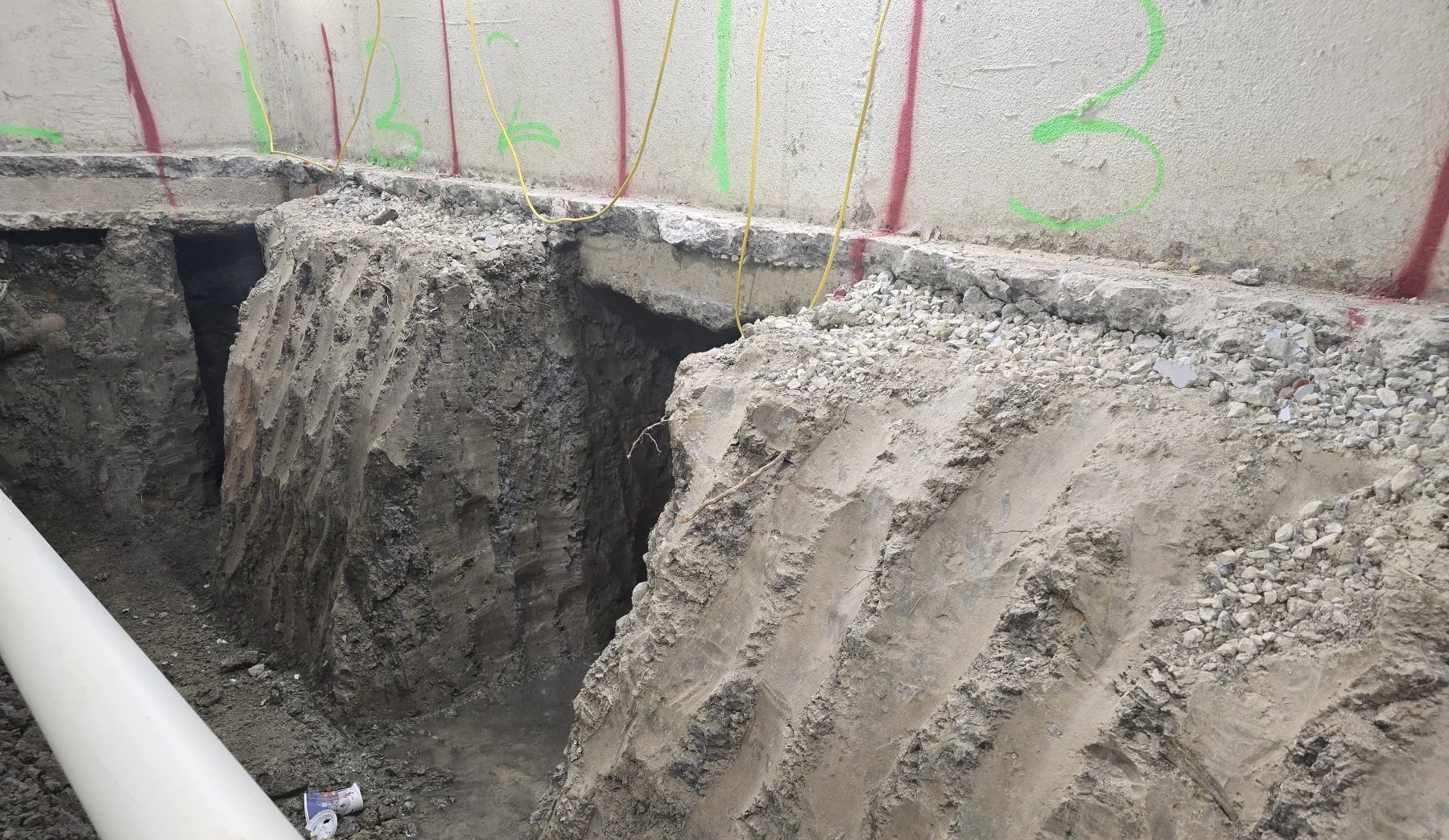 Numbered underpinning excavation stages beside an existing foundation wall